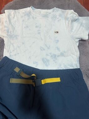 The North Face Pale Blue Tie-Dye Tee with Navy Shorts and Yellow Belt